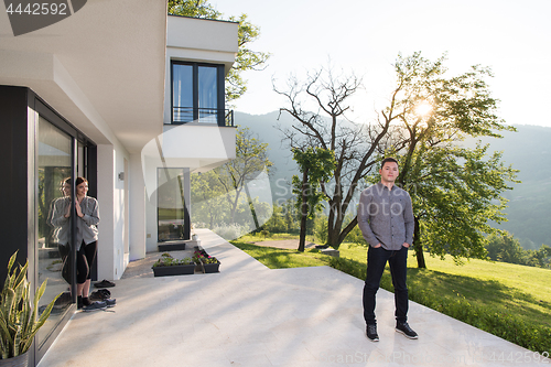 Image of man in front of his luxury home villa