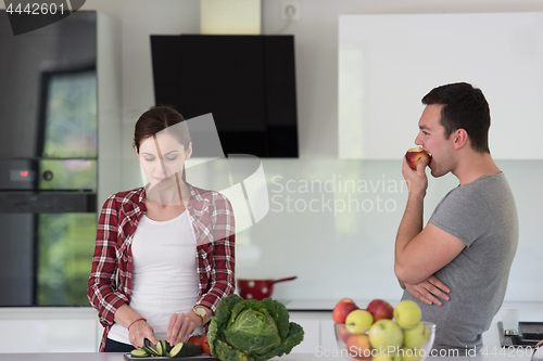 Image of Young handsome couple in the kitchen