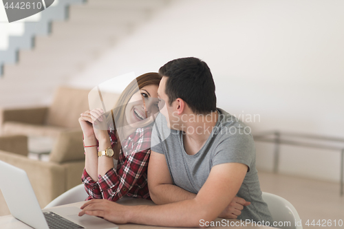Image of happy young couple buying online