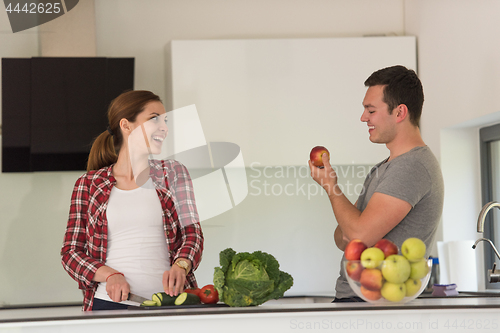 Image of Young handsome couple in the kitchen