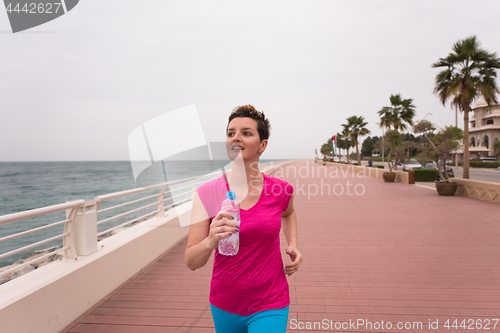 Image of woman busy running on the promenade