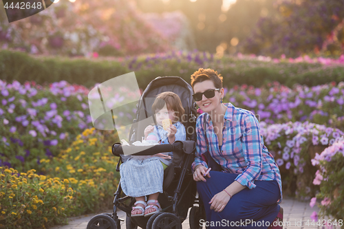 Image of mother and daughter in flower garden