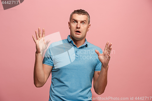 Image of Portrait of the scared man on pink