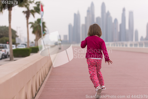 Image of cute little girl on the promenade by the sea