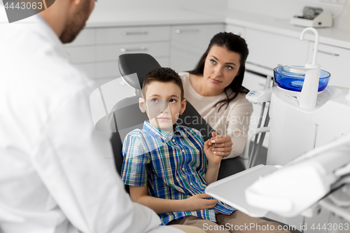 Image of mother and son visiting dentist at dental clinic