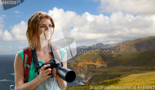 Image of woman with backpack and camera at big sur coast