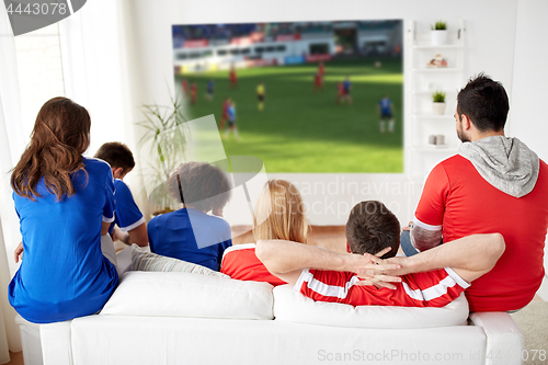 Image of friends or football fans watching soccer at home