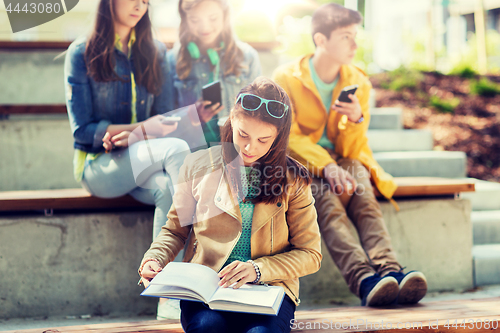 Image of high school student girl reading book outdoors