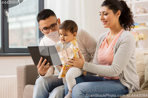 Image of mother, father and baby with tablet pc at home