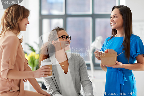 Image of businesswomen having lunch at office