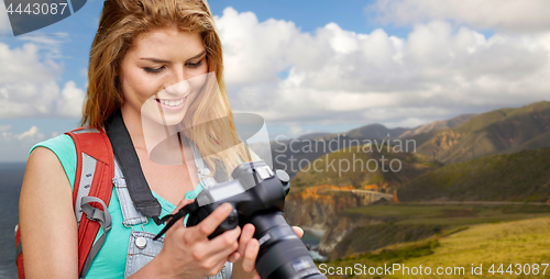 Image of woman with backpack and camera at big sur coast