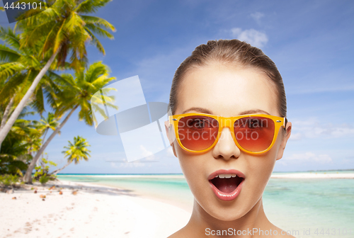 Image of happy woman or teenage girl in sunglasses on beach