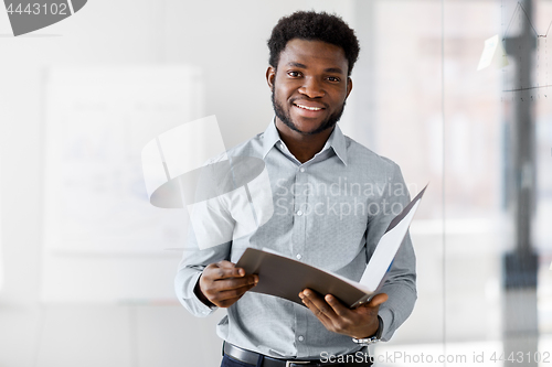 Image of african american businessman with folder at office