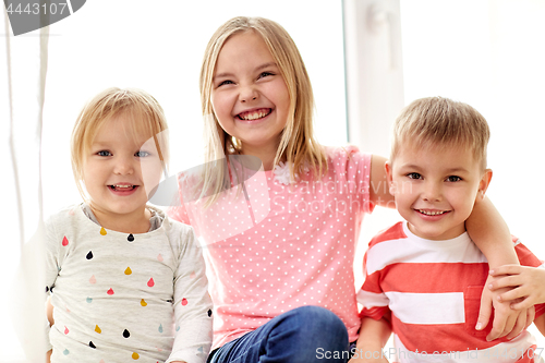 Image of happy little kids hugging at window