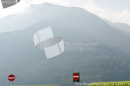 Image of Road signs in misty mountains