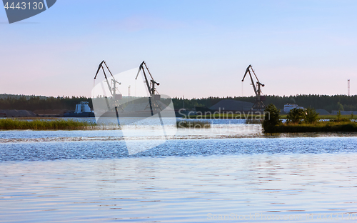 Image of Port With Loading Cranes On The River Bank