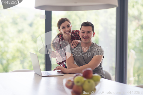 Image of happy young couple buying online