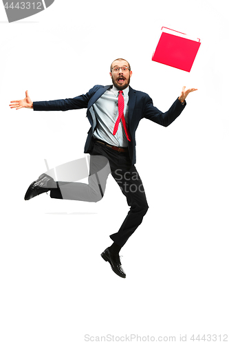 Image of Funny cheerful businessman jumping in air over white background