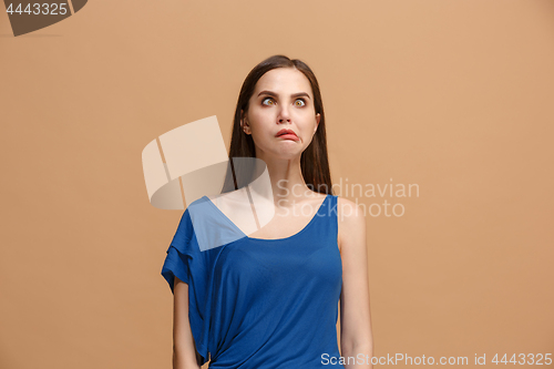 Image of The woman with weird expression isolated on pastel