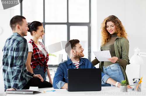 Image of creative team with laptop working at office