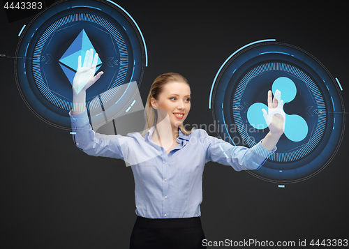 Image of businesswoman with cryptocurrency holograms