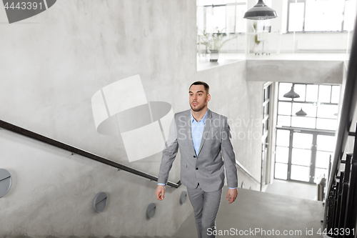 Image of businessman walking upstairs