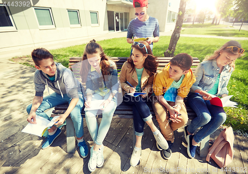 Image of group of students with notebooks at school yard