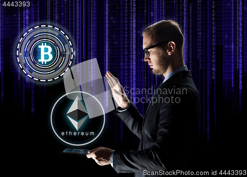 Image of businessman with tablet pc and cryptocurrency