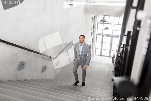 Image of businessman walking upstairs