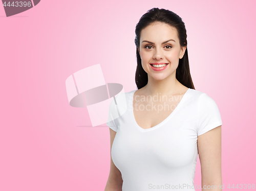 Image of happy woman in white t-shirt over pink background