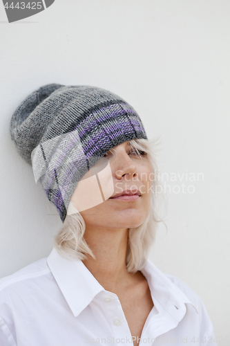 Image of Beautiful woman in warm grey beanie hat.