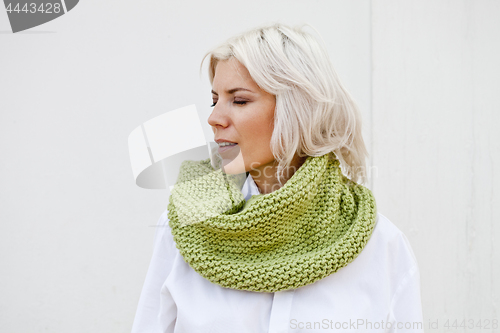 Image of Woman in warm green wool knitted snood.