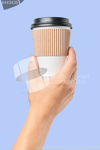Image of Mockup of men\'s hand holding white paper mid size cup with black cover