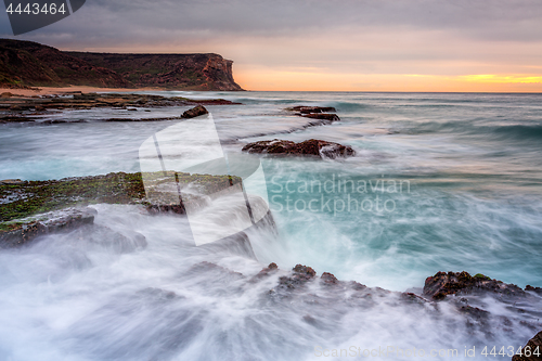 Image of Coastal sunrise waves break over rocks in Royal National Park