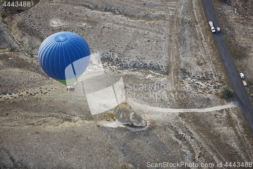 Image of Blur hot air balloon flying over the road with motor transport