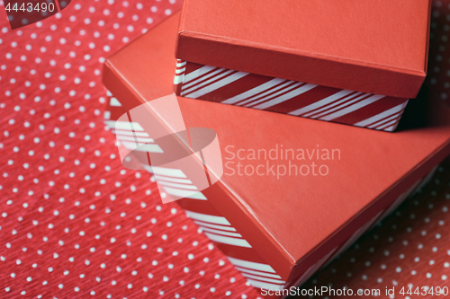 Image of Christmas gift boxes on a red wrapping paper