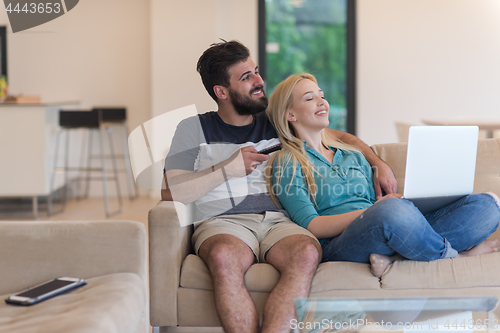 Image of young happy couple relaxes in the living room