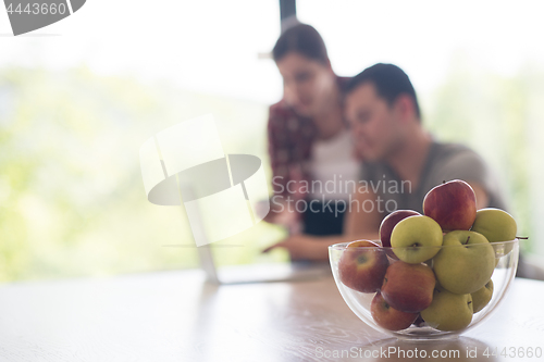 Image of happy young couple buying online