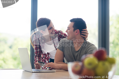 Image of happy young couple buying online