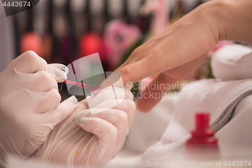 Image of Woman hands receiving a manicure