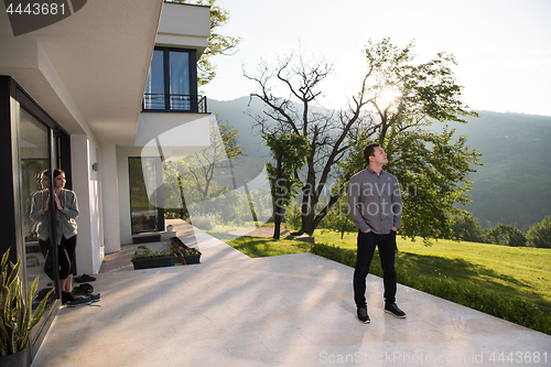 Image of man in front of his luxury home villa
