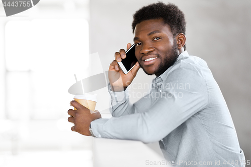 Image of businessman calling on smartphone at office