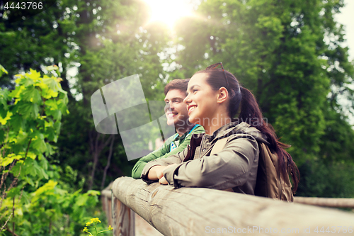 Image of smiling couple with backpacks in nature