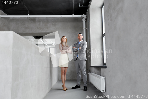 Image of smiling businesswoman and businessman at office