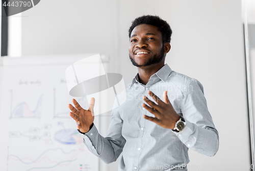 Image of businessman with flip chart at office presentation