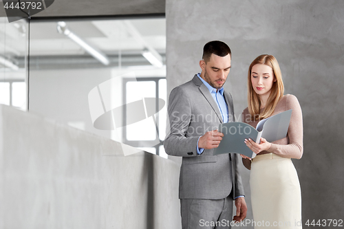 Image of businesswoman and businessman with folder