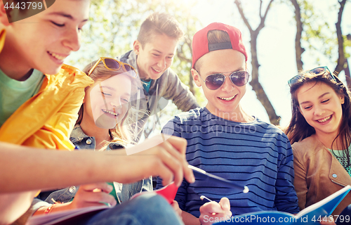 Image of group of students with notebooks at school yard