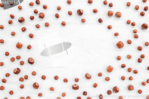 Image of Hazelnuts on white wooden background with copy space