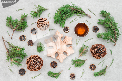 Image of Christmas decor with pine tree branches and teacup