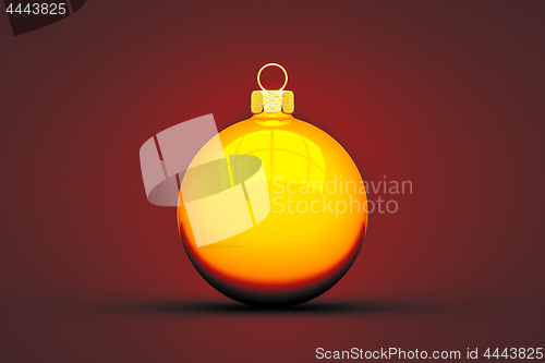 Image of yellow Christmas ball isolated on red background